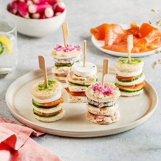 Mini sandwiches with fresh goat cheese, smoked salmon and cucumber