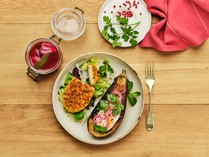 Roasted aubergine with goat cheese, salad and vegetables served as a balanced post-workout meal